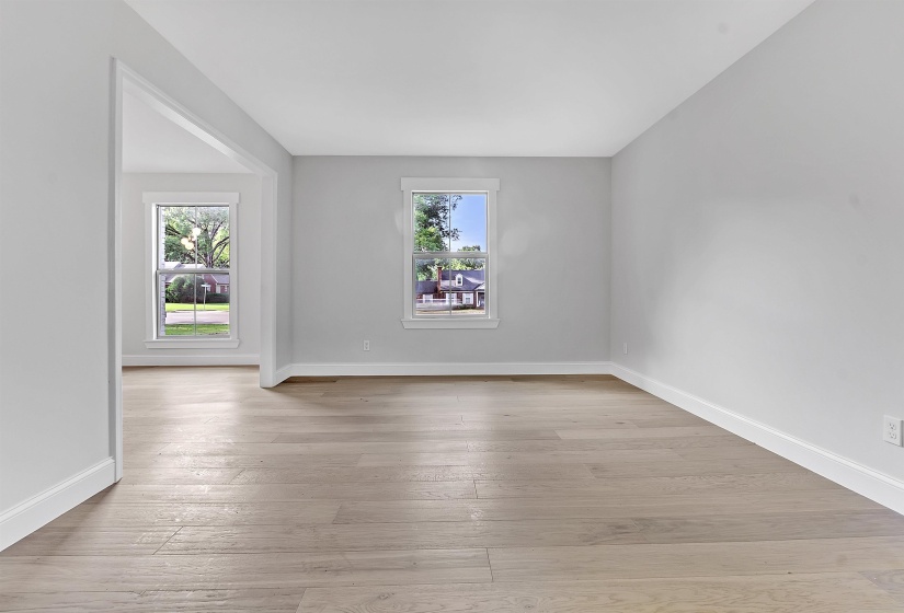 Spare room with wood-type flooring and baseboards