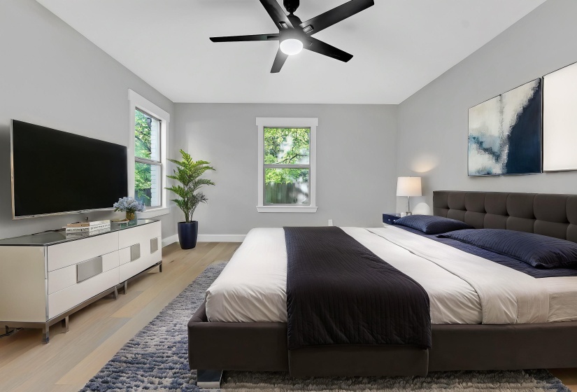 Bedroom with light wood finished floors, ceiling fan, and baseboards