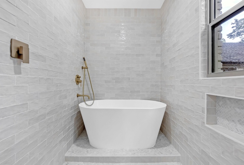 Full bathroom with tile walls, a soaking tub, and a tile shower