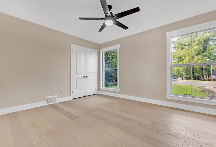 Spare room with baseboards, light wood-type flooring, and a ceiling fan