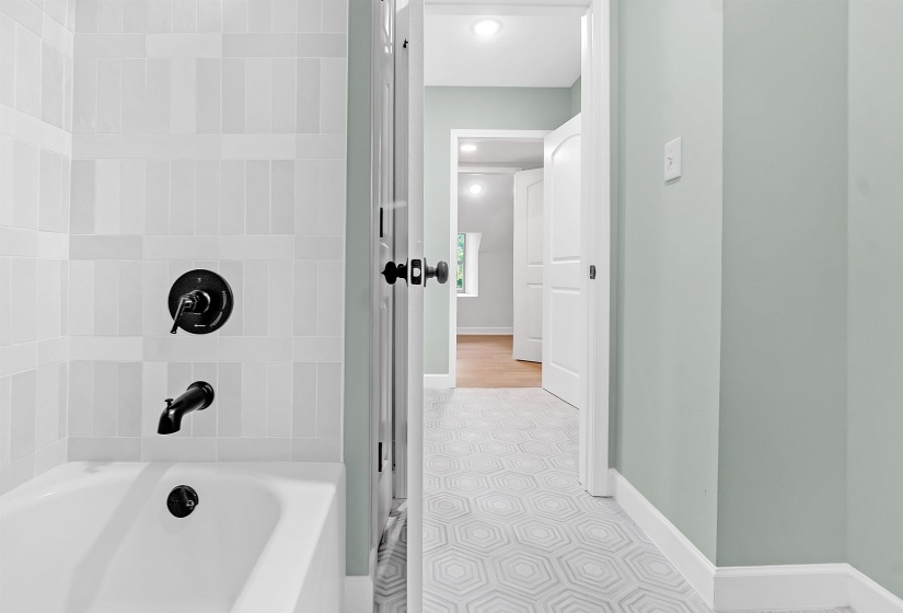 Bathroom featuring baseboards, recessed lighting, and tile patterned flooring