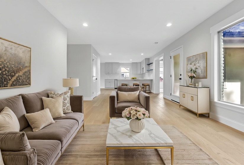 Living area with light wood-style flooring, baseboards, and recessed lighting