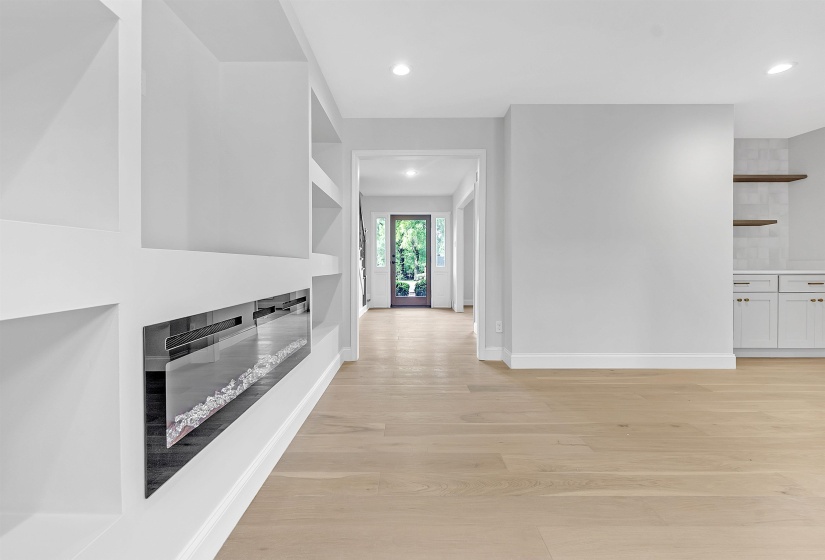 Hall featuring light wood-type flooring, baseboards, and recessed lighting