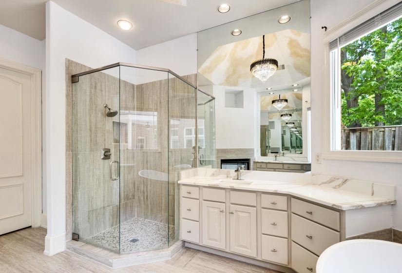 Bathroom featuring a shower stall, vanity, a fireplace, recessed lighting, and a bath