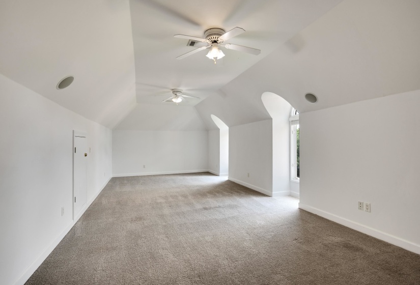 Additional living space featuring a ceiling fan, carpet, lofted ceiling, and baseboards