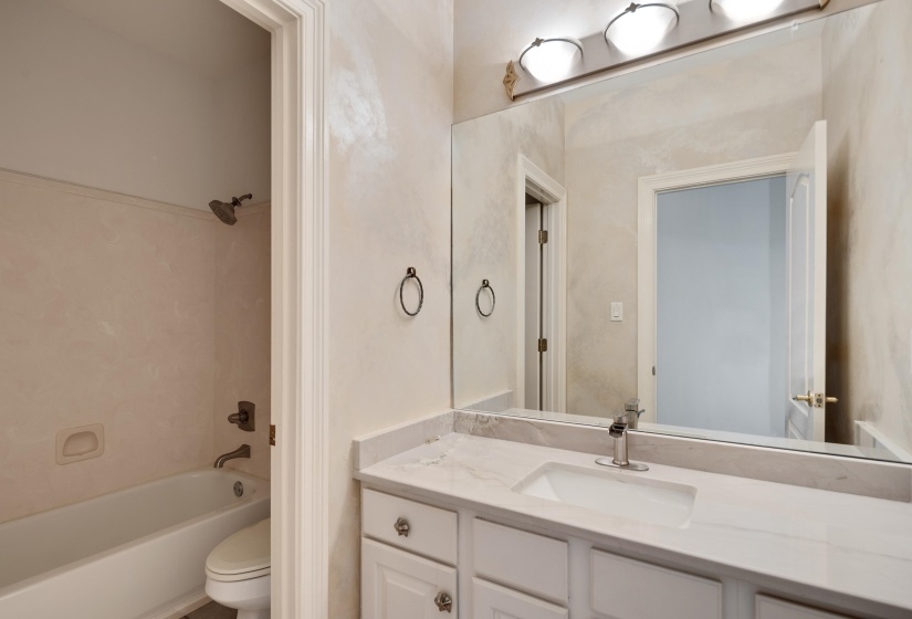 Bathroom with shower / washtub combination, vanity, and toilet