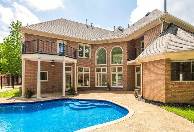 View of pool with a patio area and fence