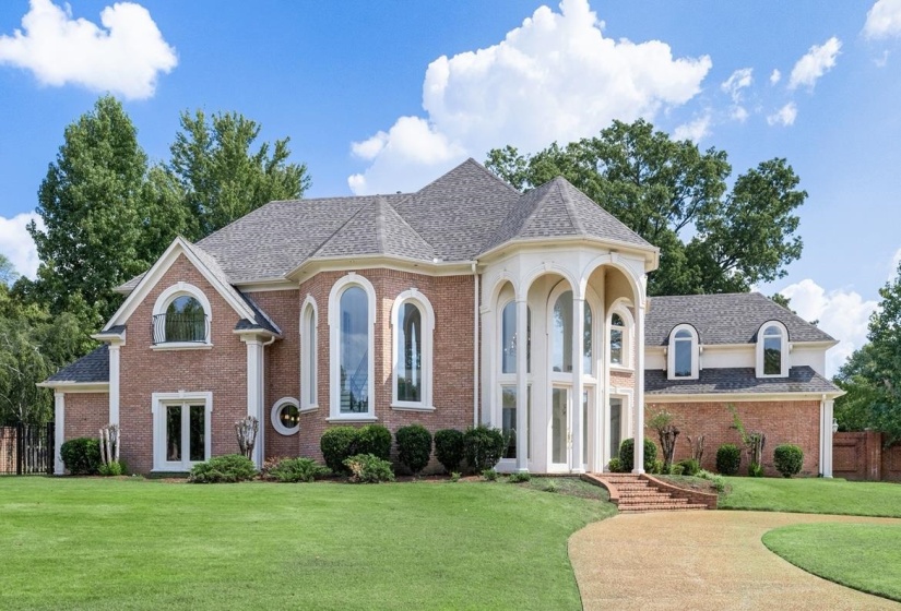 View of front of house featuring brick siding and a shingled roof
