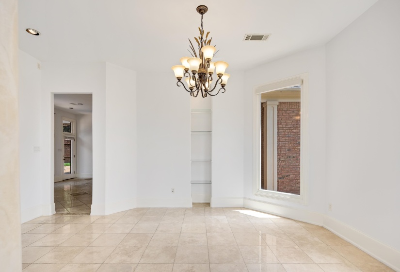 Empty room with a chandelier, light tile patterned floors, recessed lighting, and baseboards