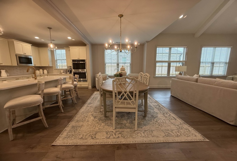 Dining room featuring a chandelier, beam ceiling, dark wood-style flooring, and recessed lighting