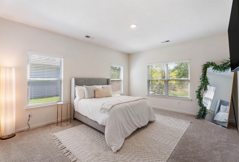 Bedroom featuring light colored carpet and baseboards