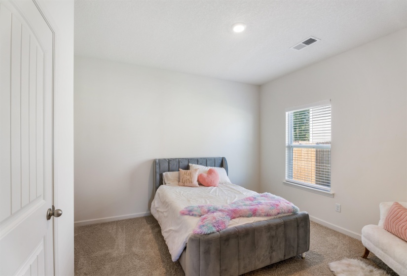 Carpeted bedroom featuring baseboards and recessed lighting