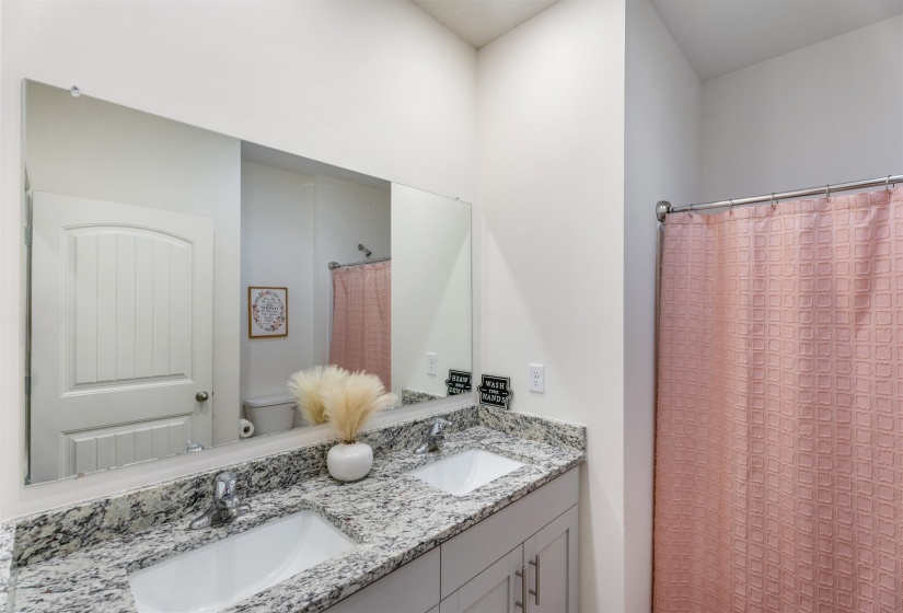 Full bath with toilet and double vanity