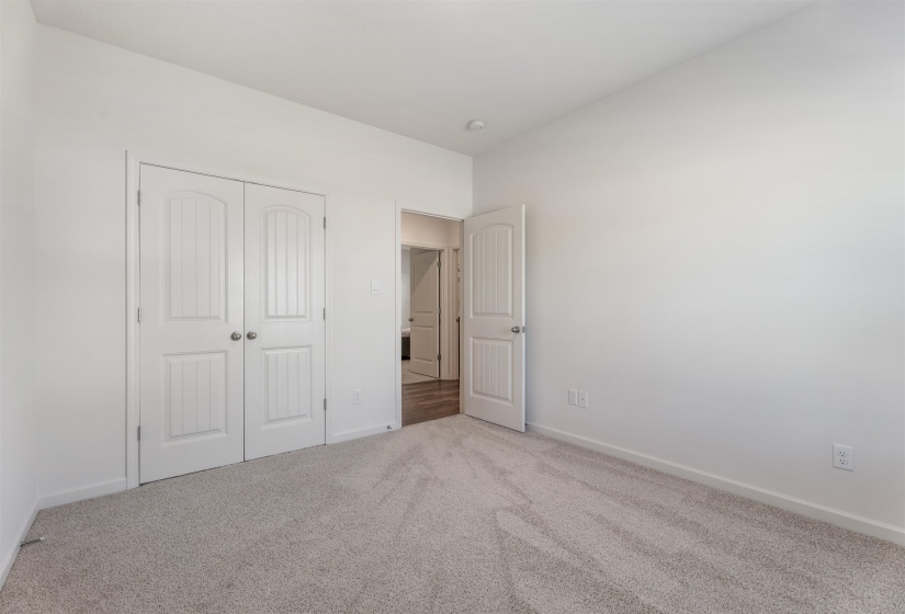 Unfurnished bedroom featuring carpet, baseboards, and a closet