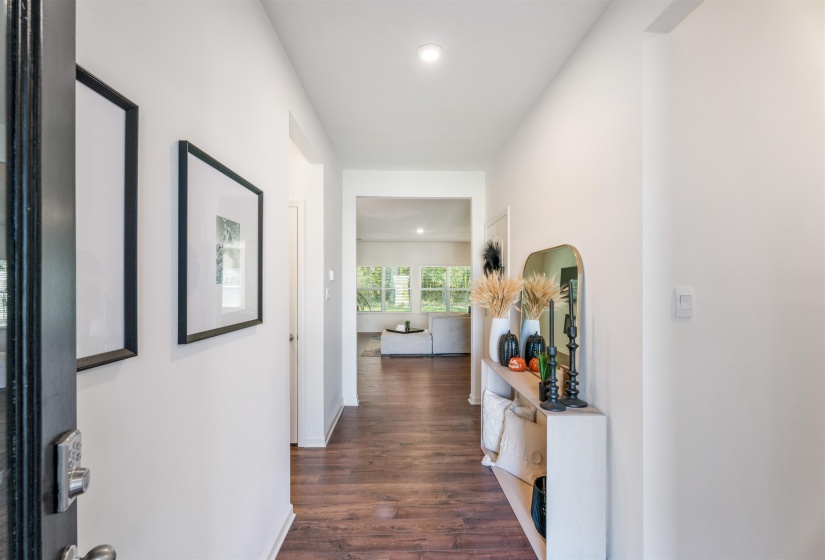 Hallway featuring dark wood-type flooring, recessed lighting, and baseboards