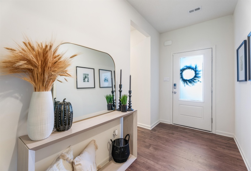 Entryway with dark wood-style flooring and baseboards