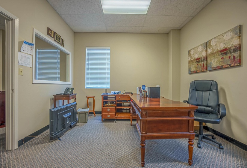 Office space featuring a drop ceiling and carpet