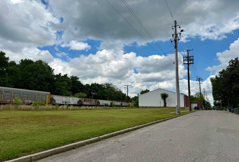 View of asphalt road with curbs