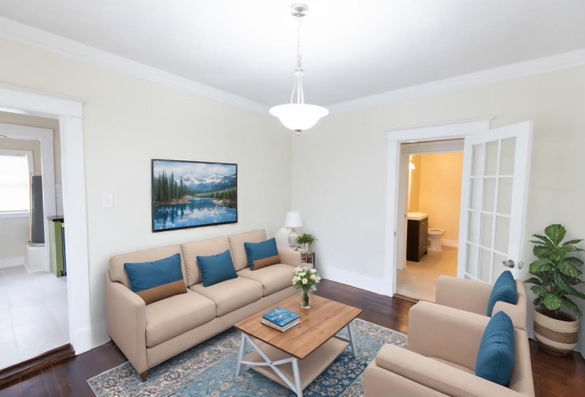 Living room with crown molding and dark hardwood / wood-style floors