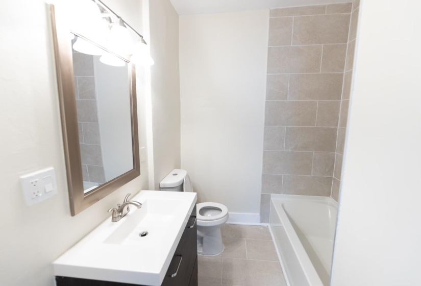 Bathroom with vanity, toilet, and tile patterned flooring