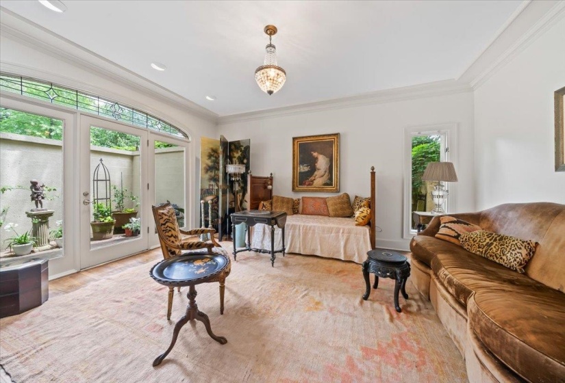 Primary Bedroom featuring plenty of natural light, ornamental molding, private access to patio