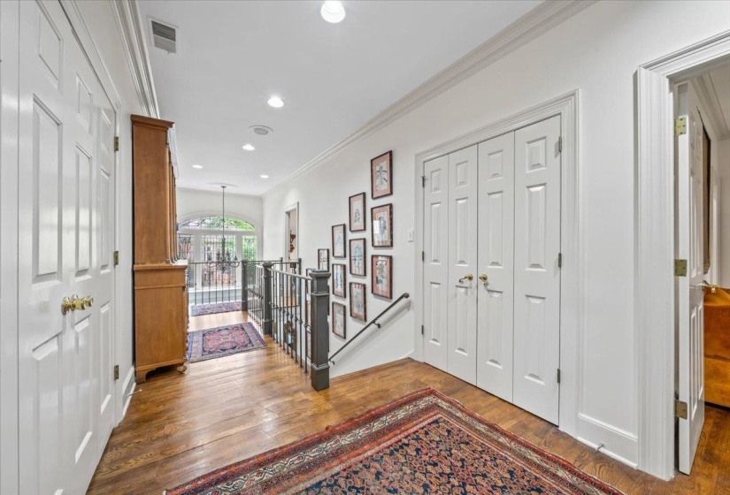 Entryway with wood finished floors, ornamental molding, and recessed lighting