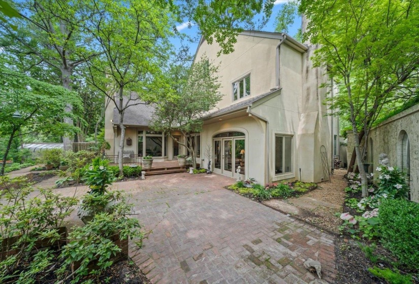 Back of property with stucco siding, french doors, and a patio