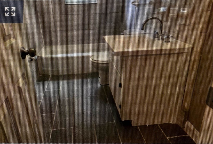 Bathroom with toilet, vanity, bathing tub / shower combination, and tile walls