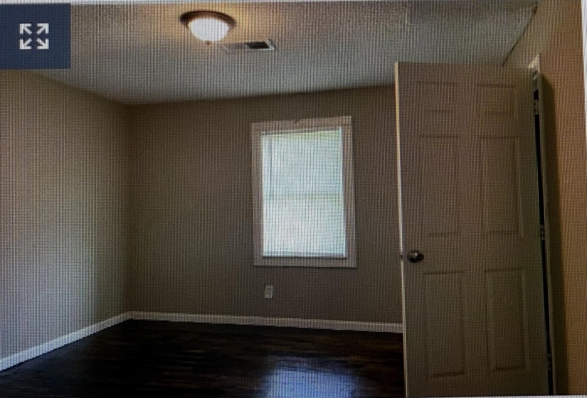Unfurnished room with baseboards and dark wood finished floors
