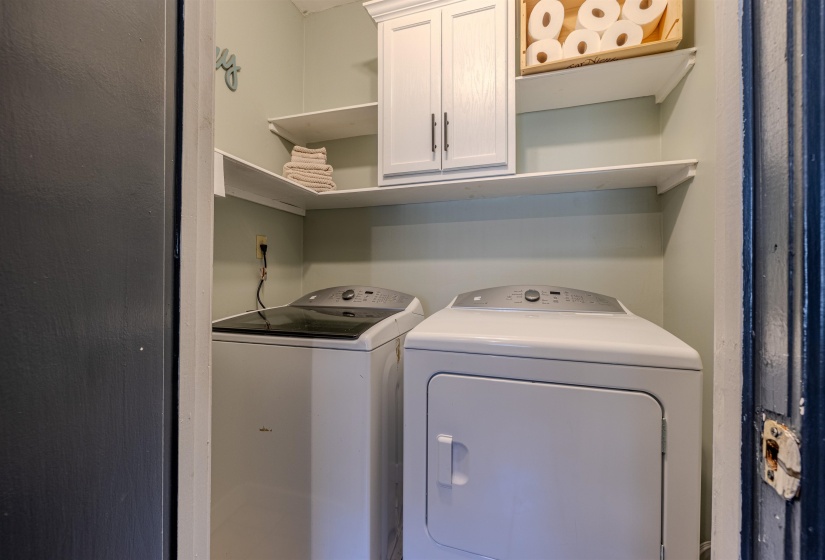 Laundry area with independent washer and dryer and cabinet space