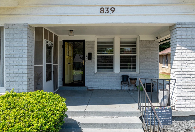 View of exterior entry featuring brick siding