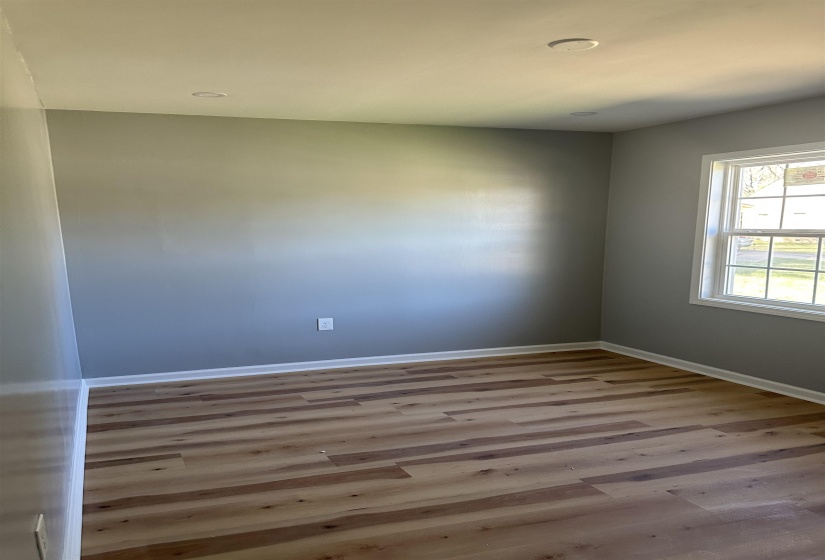 Unfurnished room featuring baseboards and wood finished floors
