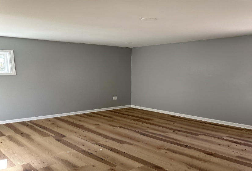 Unfurnished room with baseboards and wood finished floors