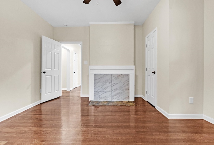 Empty room featuring a ceiling fan, wood finished floors, and baseboards