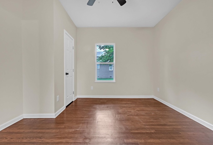 Spare room with ceiling fan, wood finished floors, and baseboards