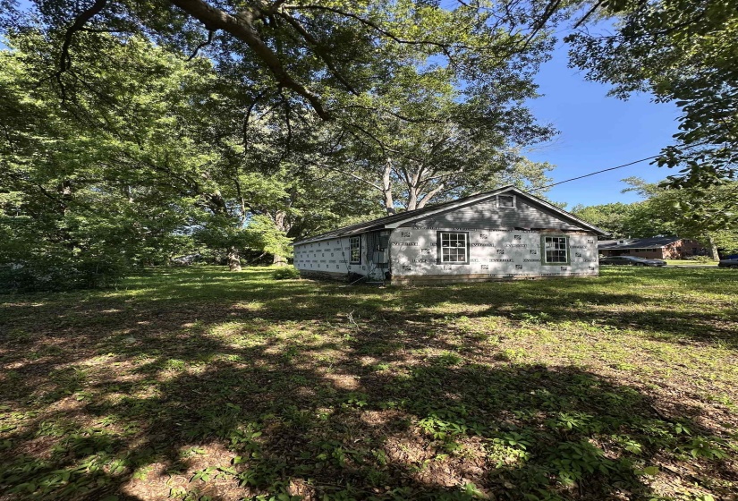 View of side of home with a yard