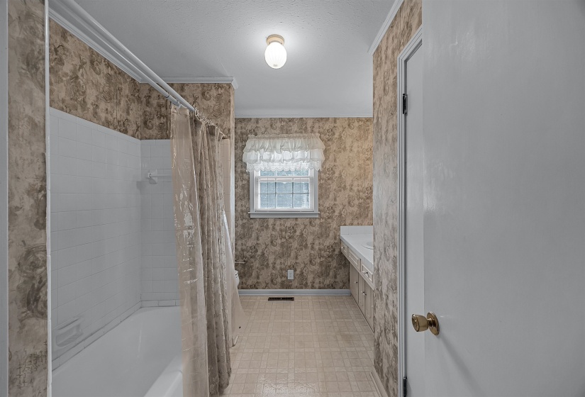 Bathroom with vanity, tile patterned floors, and shower / tub combo