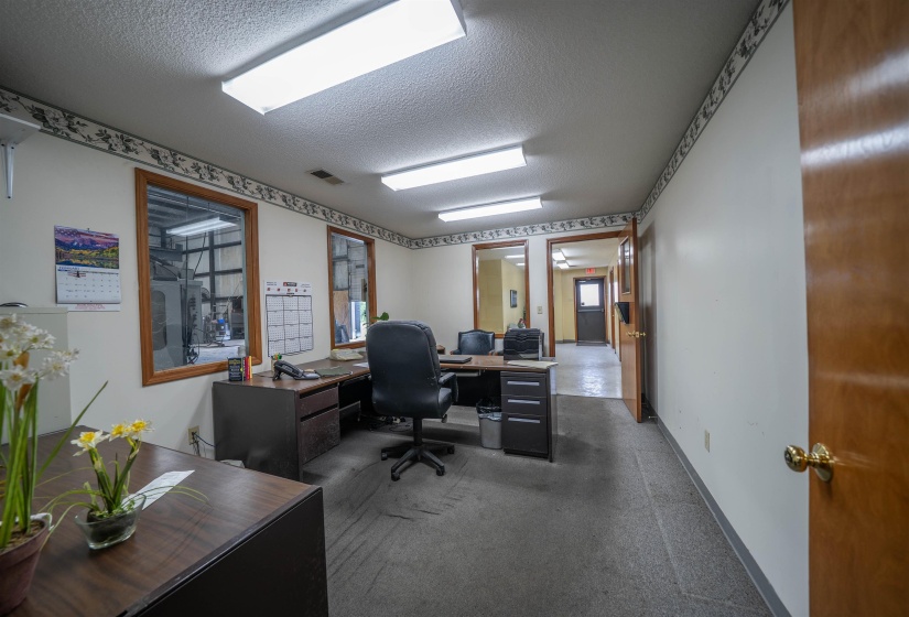 Home office featuring a textured ceiling and carpet