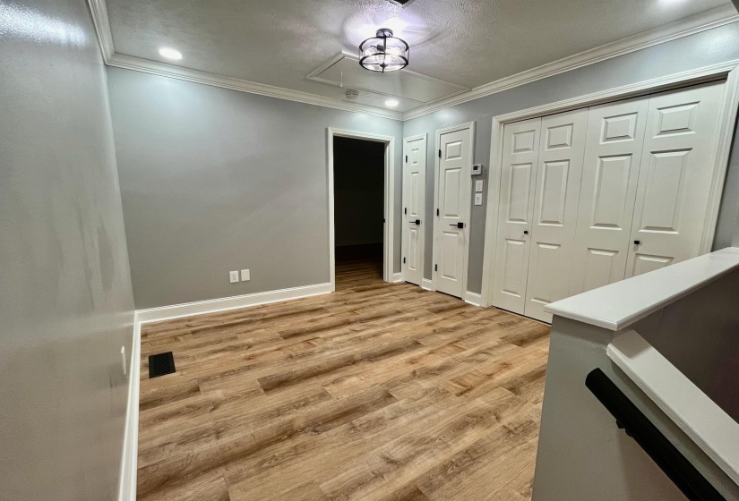 Entryway with baseboards, ornamental molding, and light wood finished floors