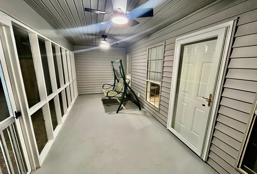 Exercise room with wood walls and a ceiling fan