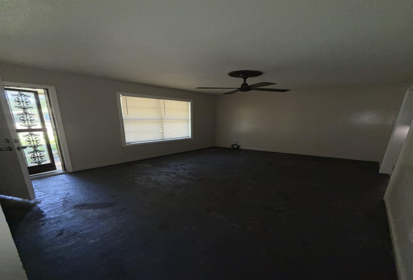 Empty room with plenty of natural light and a ceiling fan