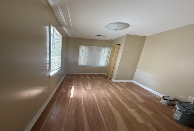 Spare room featuring wood finished floors and baseboards
