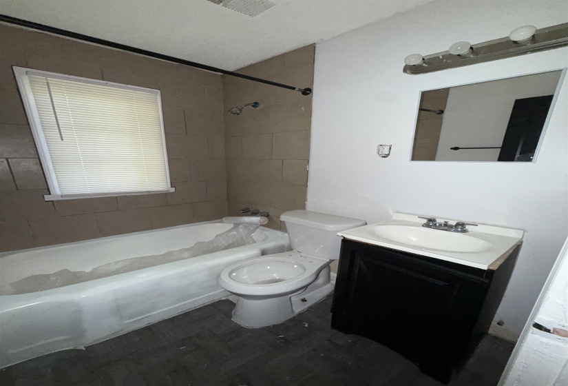 Bathroom featuring toilet, shower / tub combination, and vanity