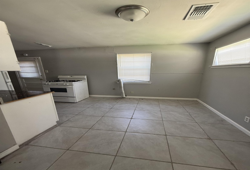 Unfurnished dining area featuring light tile patterned floors and baseboards
