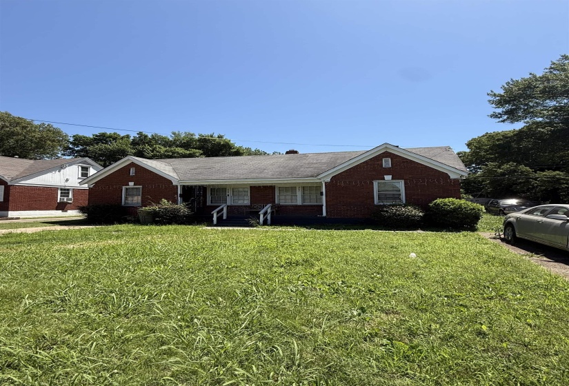 Ranch-style house featuring a front yard and brick siding