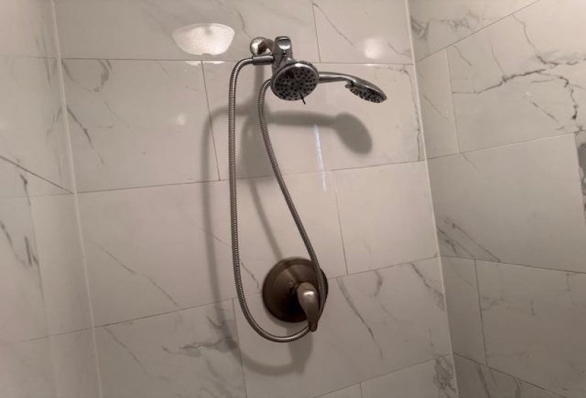 Room details with tiled shower