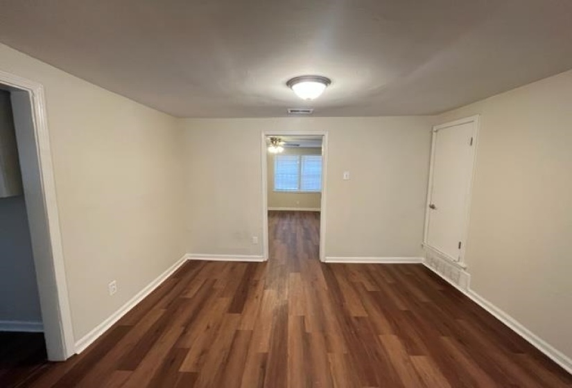 Empty room featuring wood finished floors and baseboards
