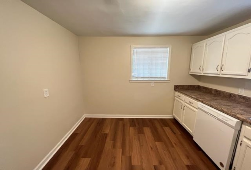 Washroom with baseboards and dark wood-type flooring