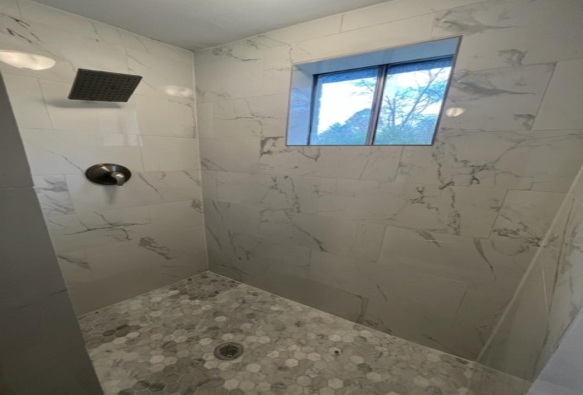 Full bathroom with a tile shower