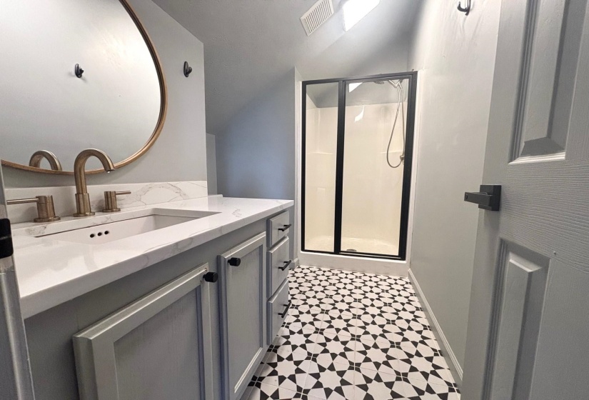 Ensuite Bathroom featuring vanity, a stall shower, and tile patterned floors